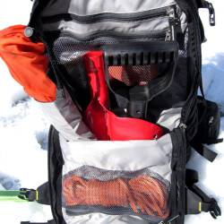 Avalanche gear / safety gear compartment. Three interior mesh pockets, probe sleeve, and shovel head pouch. Compartment is waterproof fabric against other compartments.